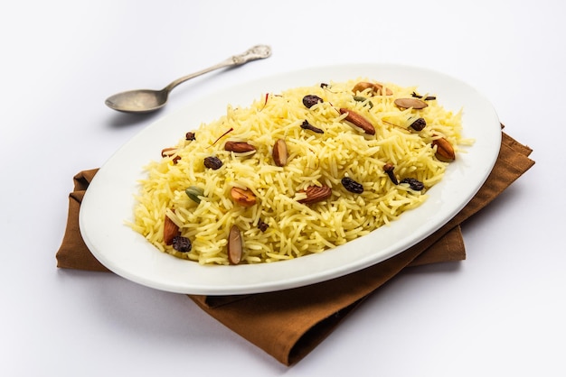 Kashmiri sweet modur pulao made of rice cooked with sugar water flavored with Saffron and dry fruits