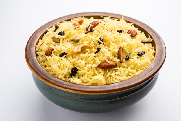 Kashmiri sweet modur pulao made of rice cooked with sugar water flavored with Saffron and dry fruits