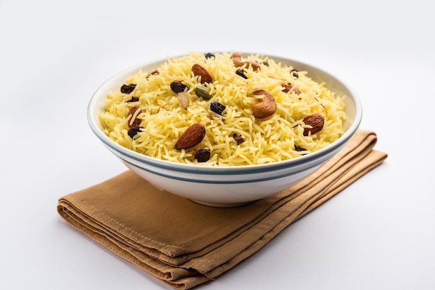 Kashmiri sweet modur pulao made of rice cooked with sugar water flavored with Saffron and dry fruits