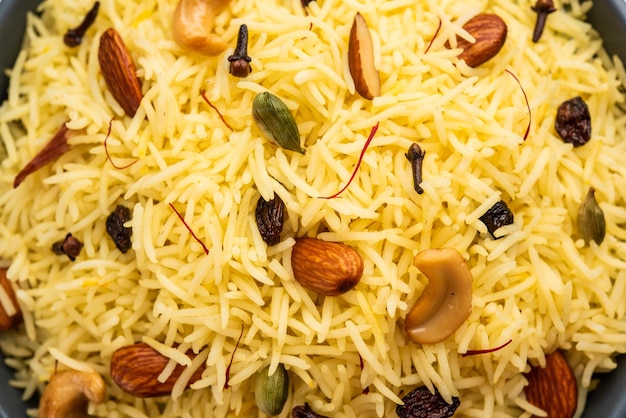 Kashmiri sweet modur pulao made of rice cooked with sugar water flavored with Saffron and dry fruits