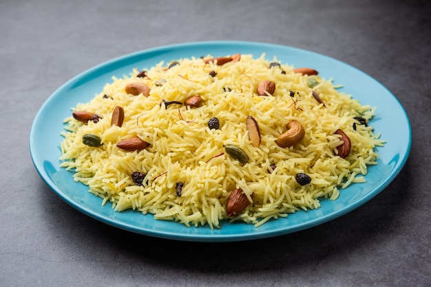 Kashmiri sweet modur pulao made of rice cooked with sugar water flavored with Saffron and dry fruits