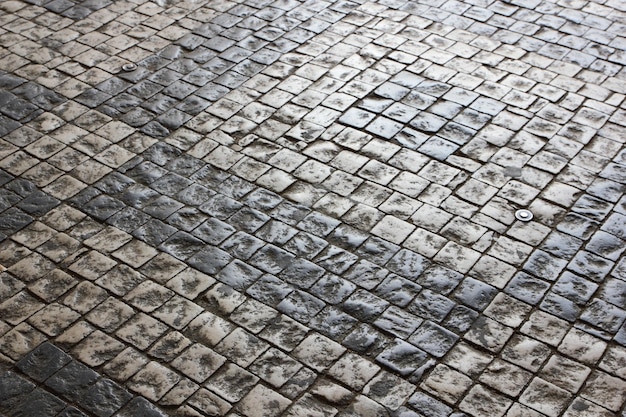 Kasseien close-up Oude weg omzoomd met steen Textuur van gladde stenen Achtergrond oude stenen weg in de stad