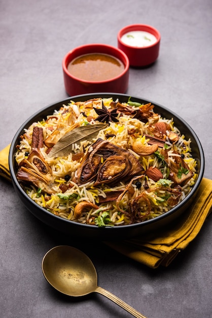Kathal Biryani is made using raw jackfruit pieces cooked slowly with a variety of spices and mixed with basmati rice. served with curd and salan. Indian vegetarian food