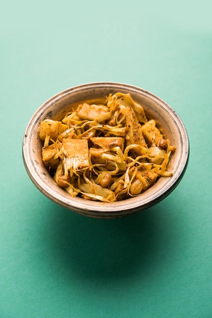 Kathal, Fanas ki Sukhi Sabzi or Bhaji known as  Spicy Jackfruit dry Vegetable recipe, served in a white bowl over moody background. Selective focus