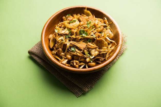 Kathal, Fanas ki Sukhi Sabzi or Bhaji known as  Spicy Jackfruit dry Vegetable recipe, served in a white bowl over moody background. Selective focus