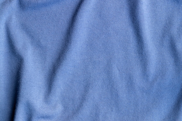 Foto katoenen jersey stof textuur. verfrommeld blauw textiel achtergrond