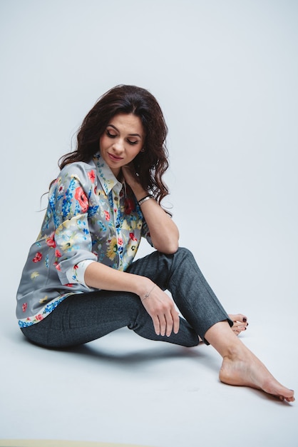 Foto kaukasisch krullend haar brunette met blauwe ogen en nude make-up met in de kleur shirt