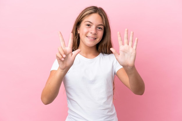 Kaukasisch meisje geïsoleerd op roze achtergrond die acht met vingers telt