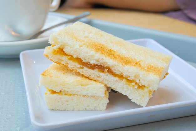 Kaya toast with a cup of tea on table