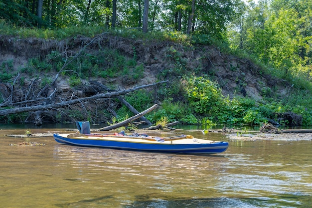 The kayak is moored against the background of the river rafting\
on the fast river adventure traveling lifestyle concept wanderlust\
active weekend vacations wild nature outdoor