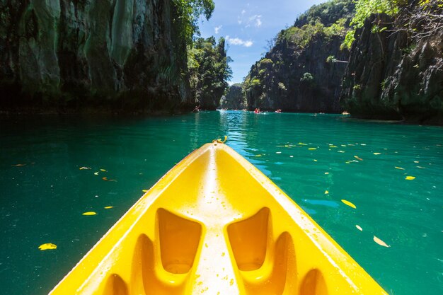 Kayak in the island lagoon between mountains. Kayaking journey in El Nido, Palawan, Philippines.