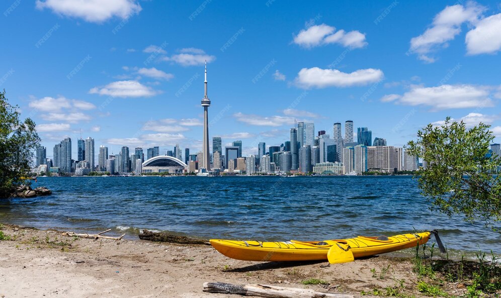 Premium Photo A kayak on toronto islands shore toronto city downtown skyline in the background