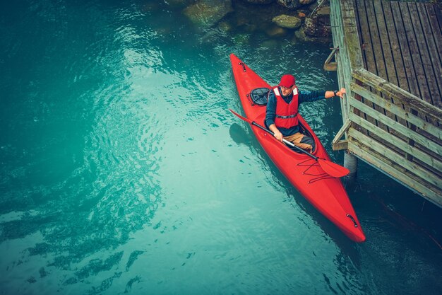 Kayaker preparing for scenic tour along glacial lake in the norway water sports and recreation theme