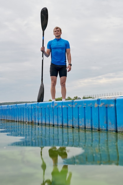 Kayaker standing with paddle