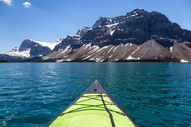 Kayaking in a glacier lake during a vibrant sunny summer day