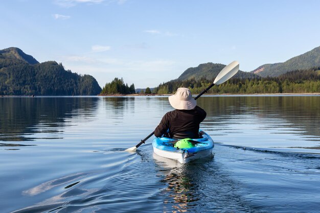 Kayaking during a vibrant morning surrounded by the Canadian Mountain Landscape