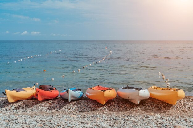 Kayaks rental place on the beach surfboards different kayaks on\
the beach water sport happy active