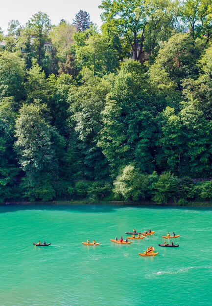 Kayaks on the river Aare. Rafting on the river Aare. Swimmers in Bern