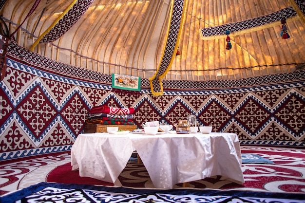 Kazak yurt interior with traditional felt carpets and furniture