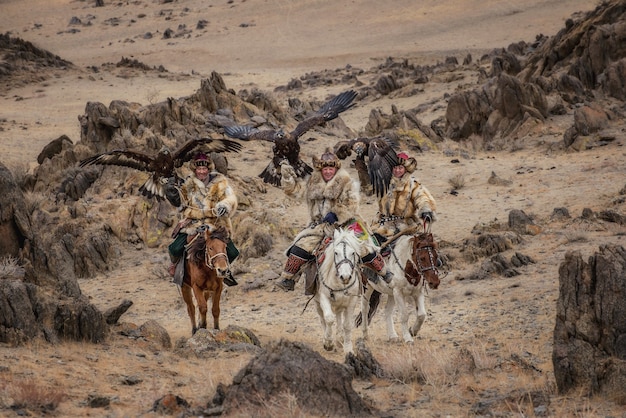 Kazakh Eagle Hunters in traditionally wearing typical Mongolian dress