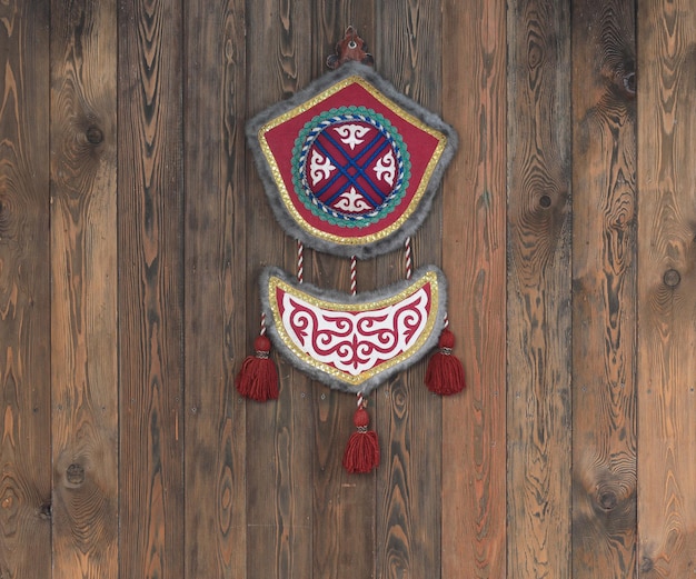 Kazakh felt ornament on wooden background