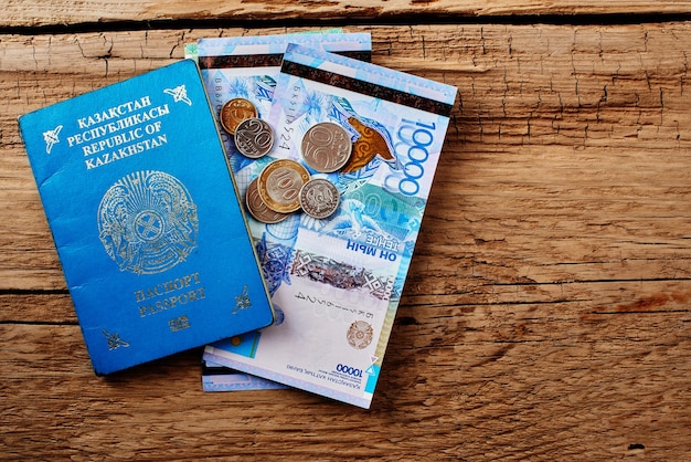 Kazakhstan money and passport on wooden table close up