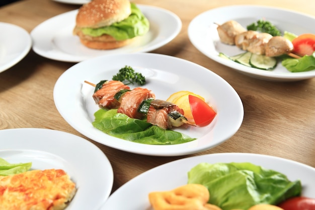 Kebab,Burger and salads on the table