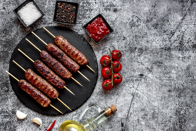 A kebab with a bottle of red wine on a table