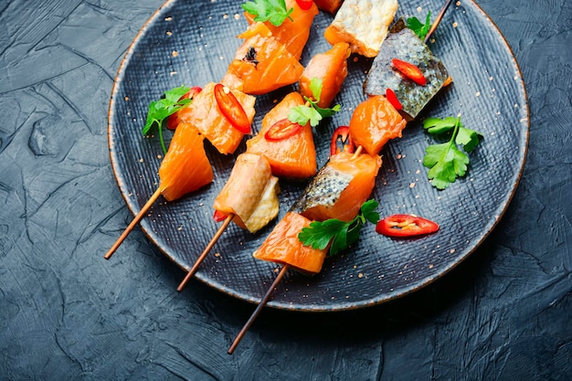 Kebabs from dried and salmon on wooden skewers.Delicious smoked fish
