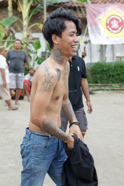 Kebumen Indonesia August 17 2022 tattooed man walking smiling