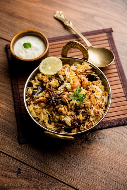 Keema or Kheema Biryani - Fragrant and spicy minced lamb or goat or chicken cooked in range of aromatic spices with basmati rice. served in a karahi with curd. selective focus