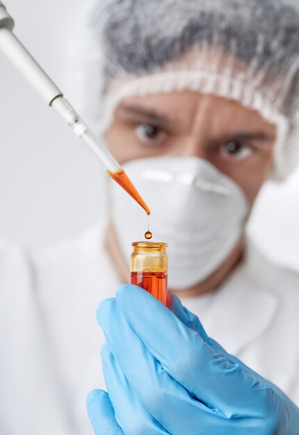 Keen scientist with brown eyes in protective wear