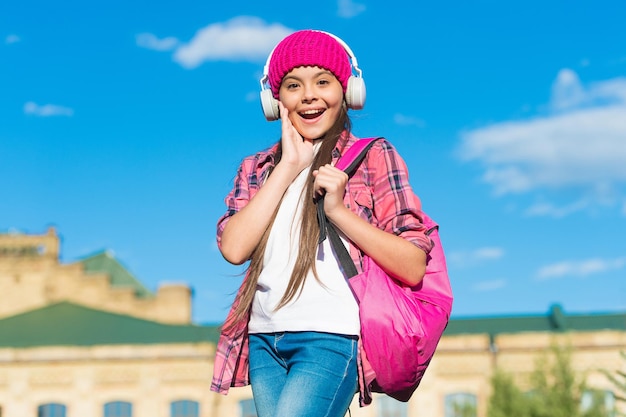 Keep calm and listen on. Happy kid listen to music sunny outdoors. Learning language. Listening comprehension skills. English school. Musical education. Courses available on audio.