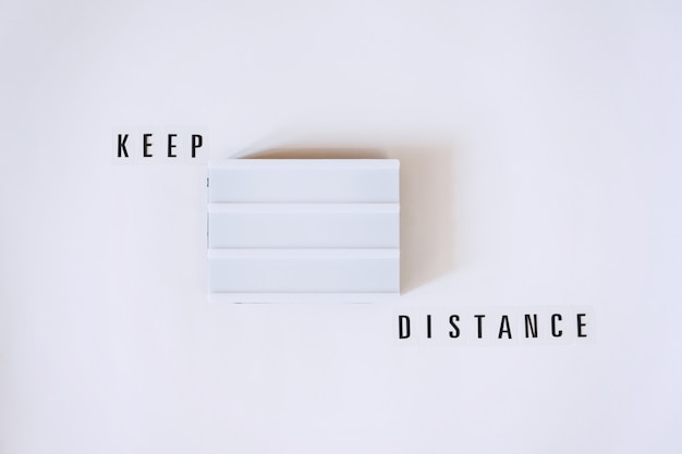 Keep Distance, social distancing concept with lightbox