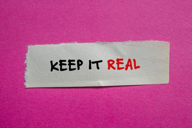Keep it real words written on torn paper piece with pink background