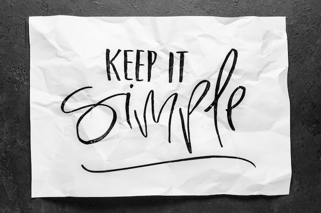 Keep it simple Lettering on crumpled white paper Handwritten text Inspirational quotes