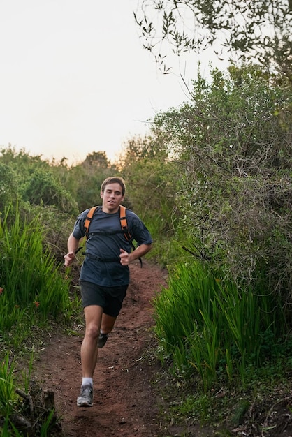 Keeping up a good pace Full length shot of a handsome male athlete running on a forest trail