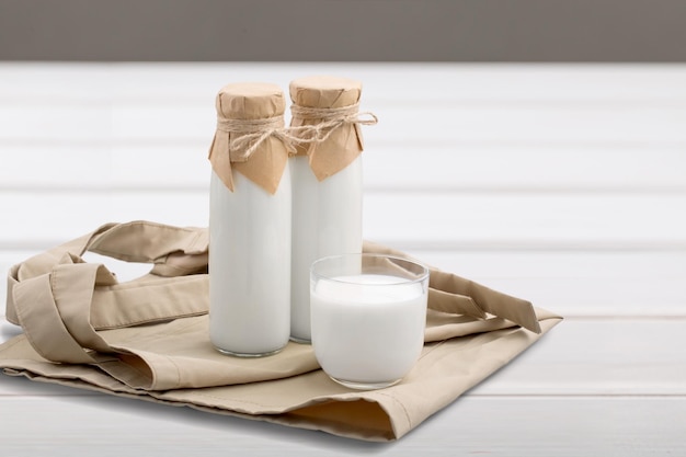 Kefir, buttermilk or yogurt in glass on wooden desk