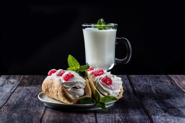 Kefir is decorated with a leaf of mint, a fermented drink. Air cake on a saucer.