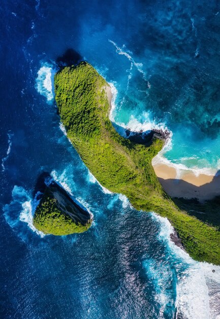 Kelingking beach nusa penida indonesia aerial view at sea and rocks blue water background from top view summer seascape from air travel and vacation image