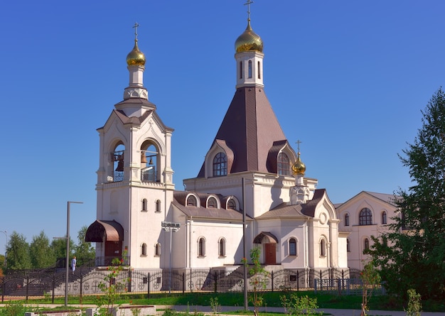 Kemerovo, Siberia, Russia-09.01.2021: A white temple with golden domes under a blue sky