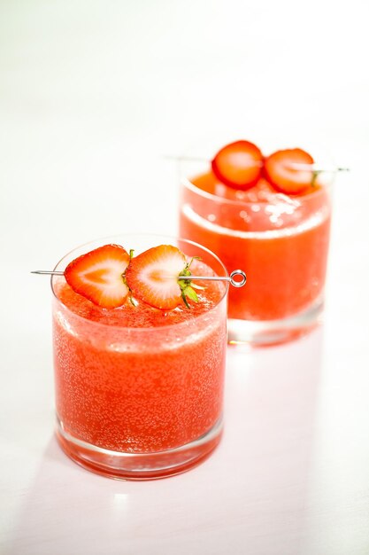 Kentucky kiss bourbon cocktail garnished with fresh strawberries.