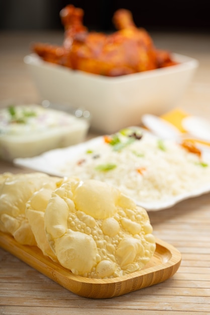 Kerala Papadum or plain pappadom  or Appalam arranged in a wooden board