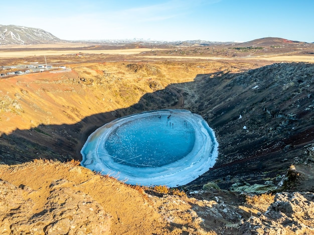 Photo kerid crater huge quiet volcanic crater in winter season become hard ice lake in iceland