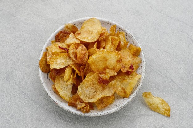 Keripik Singkong Balado Balado Spicy Chips cassava crackers on grey background Served on plate