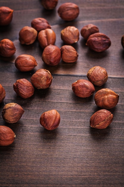 Kernels of hazelnut on vintage wooden board food and drink concept