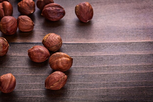 Kernels of hazelnut on vintage wooden board horizontal version food and drink concept