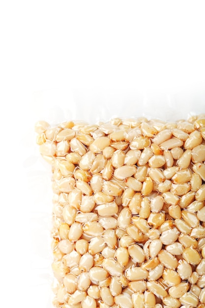 Kernels of peeled pine nuts in vacuum packaging on