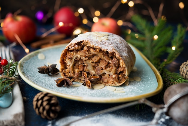 Kerst en nieuwjaar dessert. apfelstrudel met vakantielichten.