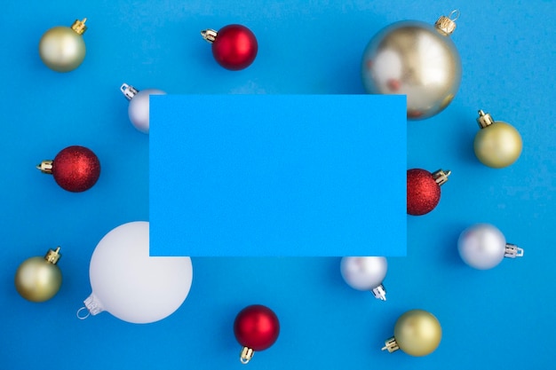 Kerst gekleurde ballen en wenskaart voor tekst op de blauwe achtergrond Kopieer ruimte Bovenaanzicht